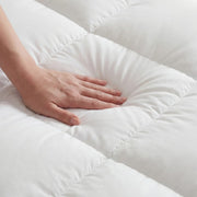 A hand pressing the soft quilted surface