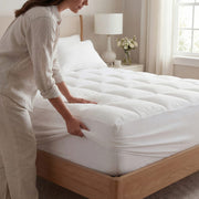 Fitting the stretch skirt around a mattress